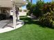 Backyard featuring a covered patio and artificial grass for easy maintenance at 6508 Alpine Forest Ct, Las Vegas, NV 89149