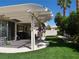 Backyard with covered patio and artificial turf and mature landscaping at 6508 Alpine Forest Ct, Las Vegas, NV 89149