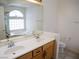 Bathroom features a double sink vanity with a large mirror, toilet, and soaking tub under a large window at 6508 Alpine Forest Ct, Las Vegas, NV 89149