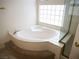 Bathroom featuring a garden tub and glass shower enclosure at 6508 Alpine Forest Ct, Las Vegas, NV 89149