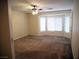 Spacious carpeted bedroom with ceiling fan and a large window allowing natural light at 6508 Alpine Forest Ct, Las Vegas, NV 89149