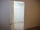 Open closet with a door and an integrated shelving system at 6508 Alpine Forest Ct, Las Vegas, NV 89149