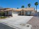 Charming single-story home with a tile roof, desert landscaping, and an attached two-car garage at 6508 Alpine Forest Ct, Las Vegas, NV 89149