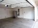Clean, spacious two-car garage featuring an additional refrigerator and access door at 6508 Alpine Forest Ct, Las Vegas, NV 89149
