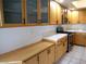 This kitchen features light wood cabinets, stainless steel appliances, and bright tile countertops at 6508 Alpine Forest Ct, Las Vegas, NV 89149