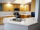 Kitchen boasts light wood cabinets, stainless steel appliances and bright tile countertops and backsplash at 6508 Alpine Forest Ct, Las Vegas, NV 89149