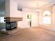 Spacious living room with a fireplace, neutral carpet, and natural light at 6508 Alpine Forest Ct, Las Vegas, NV 89149