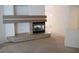 Modern fireplace feature in the living room, carpet flooring, and neutral colored walls at 6508 Alpine Forest Ct, Las Vegas, NV 89149