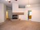 Bright living room with a fireplace, neutral carpet, and natural light at 6508 Alpine Forest Ct, Las Vegas, NV 89149