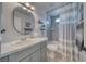 Modern bathroom featuring a stylish vanity, oval mirror, and a tub with a shower at 681 Indian Wells Ct, Pahrump, NV 89060