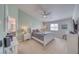 Bright bedroom with a large bed, ceiling fan, carpet, and a decorative 'Beach' sign at 681 Indian Wells Ct, Pahrump, NV 89060