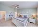 Cozy bedroom featuring a ceiling fan, neutral walls, and a comfortable bed with decorative pillows and a beach theme at 681 Indian Wells Ct, Pahrump, NV 89060