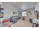 Cozy bonus room with a pull-out couch, decorative shelves, and a large window at 681 Indian Wells Ct, Pahrump, NV 89060