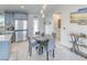 Cozy dining area with modern lighting and stainless steel appliances at 681 Indian Wells Ct, Pahrump, NV 89060