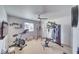 Home gym equipped with various exercise machines and a ceiling fan at 681 Indian Wells Ct, Pahrump, NV 89060