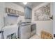 Laundry room featuring a utility sink, modern washer and dryer, and decorative decor at 681 Indian Wells Ct, Pahrump, NV 89060