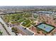 Aerial view of a park featuring tennis courts, a playground, and large green space in a planned community at 7364 Marbury St, Las Vegas, NV 89166