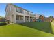 Spacious backyard with artificial grass, a play structure, and a covered patio at 7364 Marbury St, Las Vegas, NV 89166