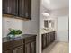 Elegant bathroom featuring dual sinks, dark wood cabinets, and stylish countertops at 7364 Marbury St, Las Vegas, NV 89166