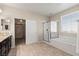Elegant bathroom featuring dual sinks, a shower, tub, and access to walk-in closet at 7364 Marbury St, Las Vegas, NV 89166