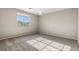 Inviting bedroom with plush carpet, a large window, and soft, neutral paint at 7364 Marbury St, Las Vegas, NV 89166