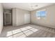Bedroom features neutral carpet, a chandelier, large window with natural light, and closet at 7364 Marbury St, Las Vegas, NV 89166