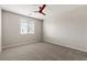 Bedroom features neutral walls and carpet, window, and ceiling fan at 7364 Marbury St, Las Vegas, NV 89166
