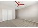 Bedroom with neutral carpet and paint, closet, window, and ceiling fan at 7364 Marbury St, Las Vegas, NV 89166