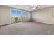 Spacious bonus room with sliding glass door to balcony and ceiling fan at 7364 Marbury St, Las Vegas, NV 89166