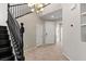 Bright entryway with a chandelier, staircase, tiled floors, and double doors at 7364 Marbury St, Las Vegas, NV 89166