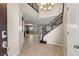Inviting entryway with staircase, tile floors, and views into the adjacent living spaces at 7364 Marbury St, Las Vegas, NV 89166