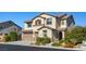 Two-story home with a two-car garage, lush landscaping, and well-manicured lawn at 7364 Marbury St, Las Vegas, NV 89166