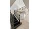 Staircase from foyer with dark wood handrails and tile flooring at 7364 Marbury St, Las Vegas, NV 89166