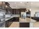 Modern kitchen features granite counters, stainless steel appliances, and dark wood cabinets at 7364 Marbury St, Las Vegas, NV 89166