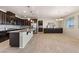 Spacious kitchen boasts dark wood cabinetry, granite countertops, stainless steel appliances, and a large center island at 7364 Marbury St, Las Vegas, NV 89166