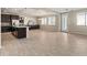 Open concept kitchen features dark wood cabinets, granite countertops, and tiled flooring at 7364 Marbury St, Las Vegas, NV 89166