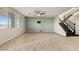 Bright, open-concept living room featuring tile floors and a staircase leading to the second floor at 7364 Marbury St, Las Vegas, NV 89166