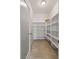 Walk-in pantry featuring tiled floors and built-in shelving at 7364 Marbury St, Las Vegas, NV 89166