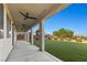 Covered patio with ceiling fans and a view of the backyard with artificial grass and playground at 7364 Marbury St, Las Vegas, NV 89166