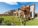 Backyard playground with swings and playhouse on artificial turf at 7364 Marbury St, Las Vegas, NV 89166