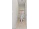 Neutral toned powder room features tile flooring, toilet, and art on display above the toilet at 7364 Marbury St, Las Vegas, NV 89166