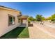 View of the home's backyard with concrete patio, rock landscaping, and artificial grass at 768 Flowing Meadow Dr, Henderson, NV 89014