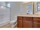 Bathroom featuring a glass enclosed shower, neutral tile, and a sink with cherry wood cabinets at 768 Flowing Meadow Dr, Henderson, NV 89014