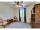 Cozy bedroom with neutral carpet, a ceiling fan, and a window with natural light at 768 Flowing Meadow Dr, Henderson, NV 89014