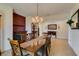 Dining room featuring a fireplace, chandelier, and arched doorway at 768 Flowing Meadow Dr, Henderson, NV 89014