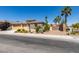 Beautiful single-story home with desert landscaping, palm trees, and a three-car garage at 768 Flowing Meadow Dr, Henderson, NV 89014