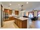 Bright kitchen with island, granite countertops, stainless steel appliances and access to the living area at 768 Flowing Meadow Dr, Henderson, NV 89014