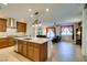 Open kitchen featuring stainless steel appliances, granite countertops, and seamlessly connected to the spacious living area at 768 Flowing Meadow Dr, Henderson, NV 89014
