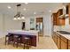 Open kitchen with stainless steel appliances, granite countertops, an island with seating, and stylish lighting at 768 Flowing Meadow Dr, Henderson, NV 89014