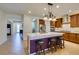 Large kitchen featuring tile flooring, granite countertops, stainless steel appliances, and an island with bar seating at 768 Flowing Meadow Dr, Henderson, NV 89014